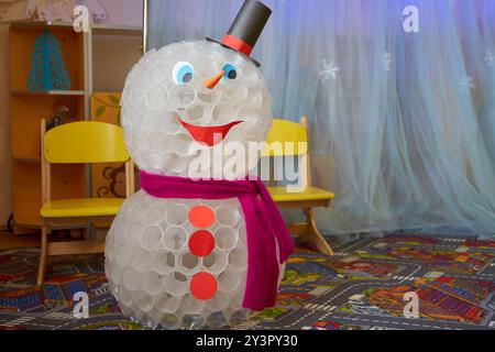 un grande pupazzo di neve fatto di tazze di plastica, un grande giocattolo per le vacanze invernali Foto Stock