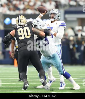 Irving, Stati Uniti. 15 settembre 2024. Il quarterback dei Dallas Cowboys Dak Prescott (4) tentò un passaggio dietro il blocco dell'offensive tackle Tyler Smith (73) contro il defensive tackle dei New Orleans Saints Bryan Bresee (90) durante una gara della National Football League all'AT&T Stadium domenica 15 settembre 2024 a Irving, Texas. (Foto di Peter G. Forest/Sipa USA) credito: SIPA USA/Alamy Live News Foto Stock