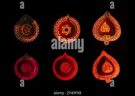 Collezione di lampade a olio di diya in argilla su sfondo scuro durante la celebrazione Diwali. Festa indù delle luci. Foto Stock