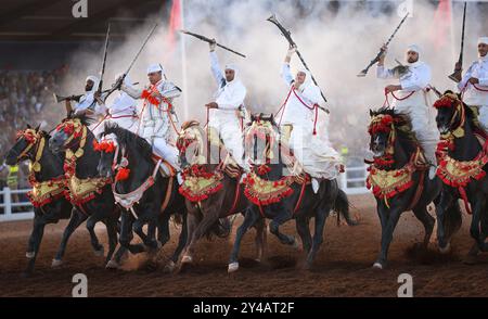 Nel cuore del Marocco, Fantasia brilla per i suoi colori vivaci e il suo potente display. Maestosi cavalli e cavalieri valorosi, avvolti da abiti vivaci, Foto Stock
