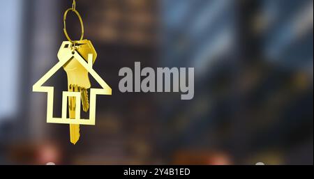 Immagine del portachiavi della casa dorata su sfondo urbano sfocato Foto Stock