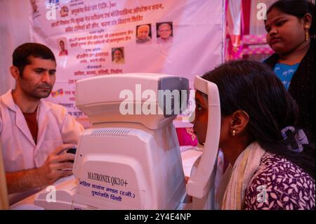 Una donna riceve un esame visivo durante un enorme campo di salute al Ramlila Ground, Red Fort. In occasione del compleanno del primo ministro indiano, Narendra modi, il Comitato lav Kush Ramlila, in collaborazione con il Ministero della giustizia sociale e dell'emancipazione, governo indiano, ha organizzato un enorme mega campo sanitario a nuova Delhi. Nell'ambito di questo programma, tricicli gratuiti, tricicli motorizzati, apparecchi acustici, arti artificiali, e sono stati distribuiti bastoncini da passeggio, e sono stati forniti servizi come controlli oculari, occhiali gratuiti e interventi di cataratta. (Foto di Pradeep Gaur/SOPA Images/ Foto Stock