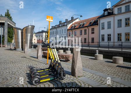 Scooter elettrici parcheggiati in un parcheggio dedicato a Norrköping. Questi veicoli sono controversi e Parigi ha votato a favore di un divieto. Foto Stock