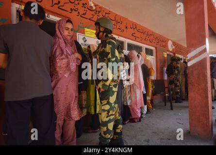 Dooru, India. 18 settembre 2024. Un soldato indiano presiede il seggio elettorale durante la prima fase delle elezioni di assemblea nello stato amministrato dall'India di Jammu e Pulwama del Kashmir. Per la prima volta in un decennio le elezioni si svolgono in tre fasi per 47 seggi di assemblea del Kashmir. Le elezioni sono anche per la prima volta dal 2019, quando nuova Delhi ha abrogato l'articolo 370 della sua costituzione che ha concesso al Kashmir l'autonomia. Crediti: Pacific Press Media Production Corp./Alamy Live News Foto Stock