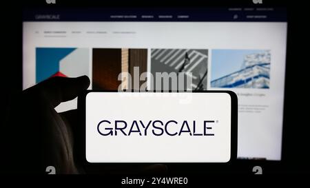 In questa immagine, il logo della società americana di gestione delle criptovalute Grayscale Investments LLC visualizzato su uno smartphone davanti alla pagina Web. Foto Stock