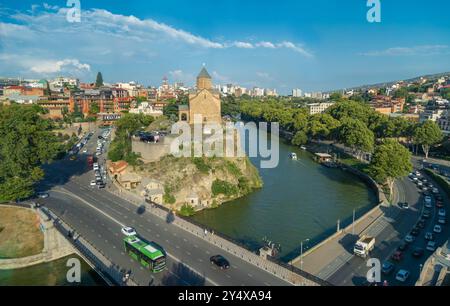 Tbilisi, Georgia - 07 agosto 2024: Vista dall'alto della città del fiume Kura con la Chiesa dell'assunzione della Vergine Maria Metekhi e la Statua del Re Vakhtang Gorgasal Foto Stock