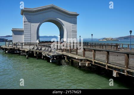 Pier 43 Ferry Arch, costruito nel 1914 per servire la Belt Railroad. Alcatraz Island dietro. Foto Stock