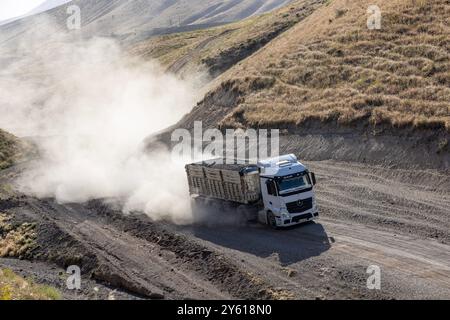 Provincia di Bitlis, Turchia, 6 luglio 2024; Mercedes Truck Driving on a Rural Road. Mercedes Truck che guida su una strada rurale polverosa a Bitlis in Turchia. Foto Stock