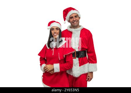 Coppia gioiosa vestita con costumi di Babbo Natale travi alla fotocamera, incarnando lo spirito festivo delle vacanze. Le loro allegre espressioni e festeggiamenti Foto Stock