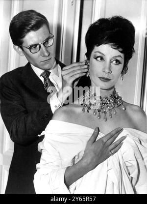 Pronto per l'apertura di Dior . PARIGI : Yves St Laurent , creatore di moda della Casa di Dior , indossa orecchini su un modello britannico ai preparativi per il futuro grande presentazione di apertura delle mode Dior 1959 - 60 per l'autunno e l'inverno . 29 luglio 1959 . Foto Stock