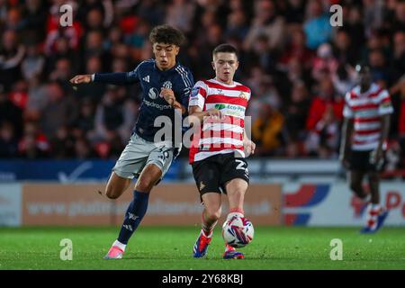 Doncaster, Inghilterra, Regno Unito il 24 settembre 2024. L'attaccante del Manchester United Ethan Wheatley (36) si batte con il centrocampista dei Doncaster Rovers Patrick Kelly (22) durante la partita Doncaster Rovers FC contro Bristol Street Motors del Manchester United FC U21 all'Eco-Power Stadium, Doncaster, Inghilterra, Regno Unito il 24 settembre 2024 Credit: Every Second Media/Alamy Live News Foto Stock