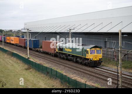 Locomotiva diesel classe 66 n. 66585 che tira un treno freightliner oltre DIRFT, Northamptonshire, Regno Unito Foto Stock