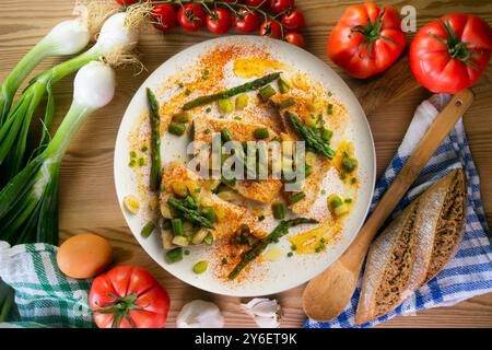 Pesce spada alla griglia con asparagi verdi. Tavolo con vista dall'alto e decorazioni. Foto Stock