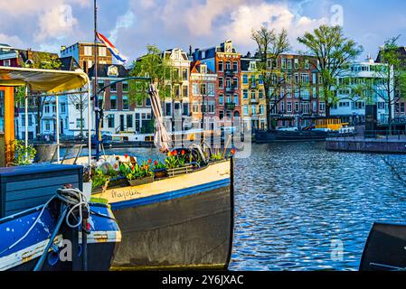 Le case di Amsterdam si riflettono nel canale all'alba Foto Stock