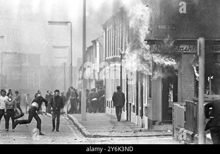 Belfast . Un giovane spinge una bomba a benzina in un negozio di moda per capelli, mettendola in luce. È stato uno dei tanti casi di rivolta e di violenza che hanno avuto luogo tra le fazioni cattoliche e protestanti della zona. 16 agosto 1969 Foto Stock