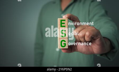 Business man Holding Globe con il testo ESG di risparmio di energia pulita ambientale, sociale, governance, sviluppo sostenibile e aziendale, ecologia f Foto Stock