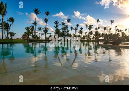 Piscina e palme in un resort di lusso a Pun Cana nella Repubblica Dominicana Foto Stock