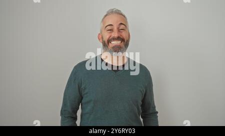 Uomo con barba sorridente in un abbigliamento casual su sfondo bianco e isolato trasuda facilità e accessibilità. Foto Stock