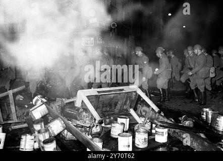 Roma : la polizia antisommossa marcia attraverso le barricate bruciate e abbandonate lasciate il 31 maggio 1968 da studenti di sinistra che cercavano di invadere l' Ambasciata francese in una manifestazione anti-De Gaulle . Foto Stock