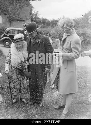 Sposa di 92 anni dopo un corteggiamento di diciotto mesi, a 92 anni di Penkridge (Wolverhampton) vedova, la signora Alice Walters sposò il signor Thomas Robinson di 58 anni, di Wheaton Aston. La signora Walters è alta appena due metri e mezzo, ma è molto attiva sia fisicamente che mentalmente. La foto mostra: "Benedici la sposa" - il signor Robinson e la sua sposa di 92 anni arrivano nella loro casa coperta di coriandoli, dopo la cerimonia nuziale. 23 luglio 1948 Foto Stock