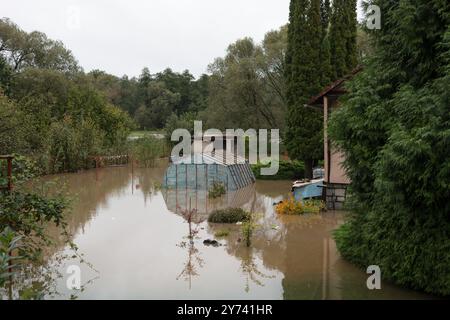 Giardino allagato dall'acqua sporca. Inondazioni e traboccamenti nel paese e nelle campagne in estate. Catastrofe naturale e distaster. Foto Stock