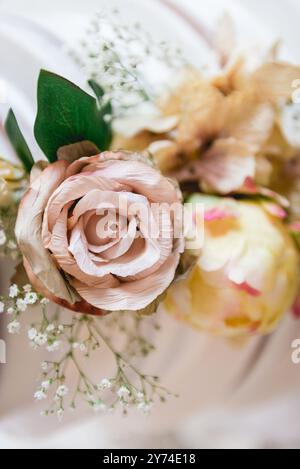 Foto ravvicinate di fiori finti con rosa blush e i colori bianco e giallo del fiato del bambino Foto Stock