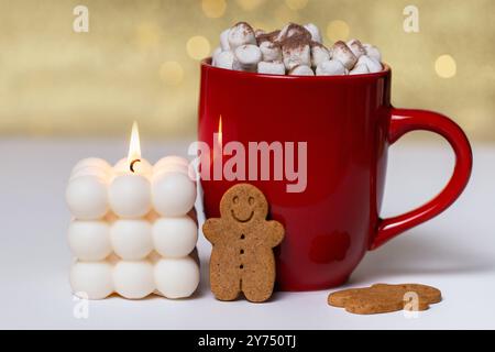 Cioccolata calda con marshmallow. Bevanda calda nella tazza rossa con biscotti a base di candela e zenzero. Foto Stock