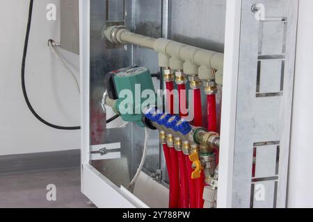 Collettore per rubinetti di riscaldamento. Armadio per la regolazione del riscaldamento a pavimento Foto Stock