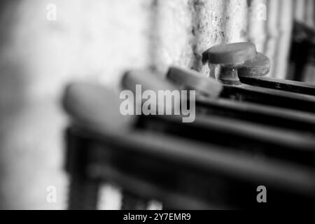 Fila di vecchi aerei in legno seduti su un banco da lavoro in un'officina polverosa, creando un'atmosfera nostalgica. - nero n bianco - Foto Stock