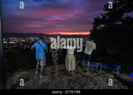 La gente gode delle vedute notturne di Kyoto dal punto di osservazione del tempio Fushimi Inari Taisha, Kyoto, Giappone Foto Stock