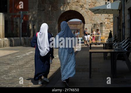 Due donne musulmane che camminano per la strada a Ávila. Foto Stock