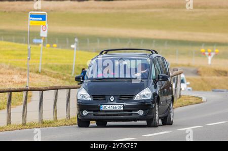 Oberglatt, Svizzera, 14 aprile 2023: Due persone guidano un Renault Espace in una strada fuori dalle pianure di Zurigo. L'auto ha una licenza Ucraina Foto Stock