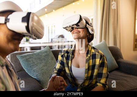 Utilizzando i visori per la realtà virtuale, la coppia può godersi l'esperienza di realtà virtuale a casa Foto Stock