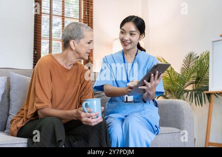 Professionista sanitario Visiting Senior a domicilio, fornendo assistenza e supporto medico Foto Stock