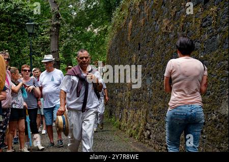 Il carreiro maturo cammina con determinazione attraverso la folla, cappello in mano Foto Stock