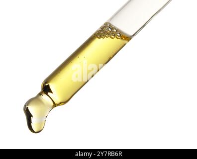 Gocciolamento di olio essenziale dalla pipetta su sfondo bianco Foto Stock