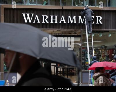 Pulitrici su scala insegna di pulizia in pioggia nel negozio Warhammer Londra Regno Unito Warhammer è un gioco da guerra in miniatura da tavolo di proprietà di Games Workshop Foto Stock