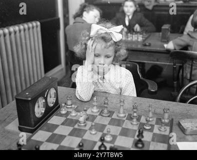 PICCOLA RAGAZZA GRANDE PROBLEMA 12 aprile 1950 portare una mente giovanile da tenere su un poser scacchistico ha 6 anni e mezzo Marian Allwright di Finchley, Londra, la più giovane concorrente del campionato di scacchi British Girls 1950 che ha avuto inizio oggi (mercoledì) presso il St Brides Institute, Ludgate Circus, Londra. La competizione che continua fino a sabato, è per le ragazze sotto i 18 anni. Nella stessa competizione si svolge il torneo Junior: Il concorrente under 15 con il miglior punteggio sarà premiato con il Trofeo Junior. Foto Stock