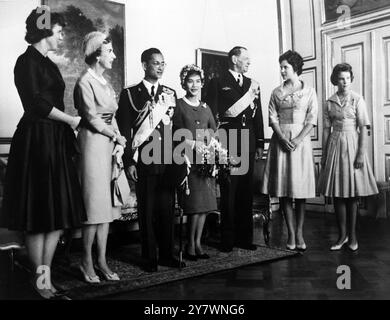 L'esotica regina Sirikit regala uno spruzzo di fiori danesi e posa per i fotografi nella residenza estiva reale danese, il Castello di Fredensborg, il 6 settembre. Fu raggiunta dal marito e dai membri della famiglia reale danese . Da sinistra a destra: Principessa Margrethe , regina Ingrid , re Bhumibol , regina Sirikit , re Frederik , principessa Benedikte e principessa Ann-Marie . La coppia reale della Thailandia è arrivata in Danimarca il giorno in cui è stata scattata la foto . Sono in viaggio per l'Europa e soggiornano in Danimarca come ospiti del Re e della Regina - 8 settembre 1960 ©TopFoto Foto Stock