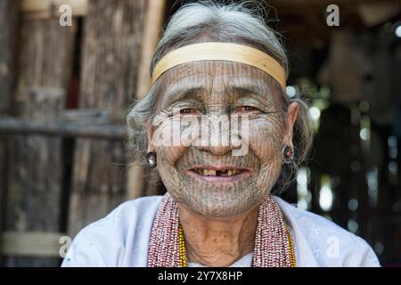 A 90 year old Yindu Chin woman with face tattoos in Kanpetlet, Myanmar. The tribal Chin women had their faces tattooed when they were around 15 years Stock Photo