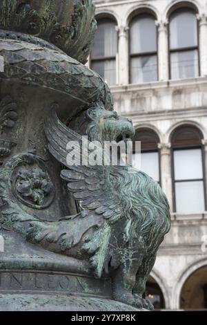 Antico ornamento di strada con leoni alati e basilica di San Marco sullo sfondo, in San Piazza Marco, famosa attrazione turistica a Venezia, Italia. Selezionare Foto Stock
