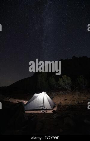 An XMid 2 tent from Durston Gear glows under the stars and the milky way galaxy in the Eastern Sierras of California. Stock Photo