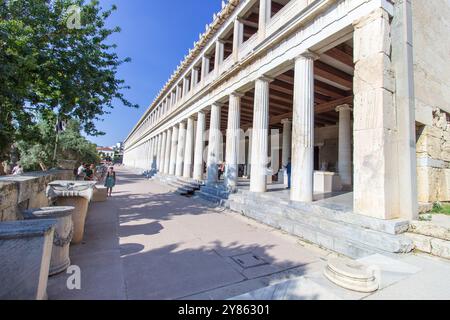 Una bella donna in piedi alle colonne del Museo dell'Antica Agorà. STOA di Attalos: Maestosa architettura ellenistica nell'Agorà di A. Foto Stock