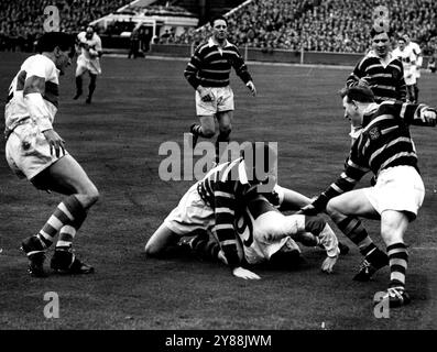 Sfaldando e fingendo, Llewelly (Sant'Elena) sfugge a una linea di difensori di Huddersfield. Per ogni uomo che passa c'è un altro davanti al suo Huddersfield che ha vinto 15-10 nella finale di Rugby League contro il St. Helens. 27 aprile 1953. (Foto di Daily Mirror). Foto Stock