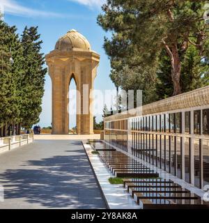 Baku, Azerbaigian - 6 maggio 2024: La corsia dei martiri onora i soldati morti nella guerra del Nagorno-Karabakh. Comprende tombe dei soldati e un monumento centrale caratterizzato da una torre di pietra con una fiamma eterna Foto Stock