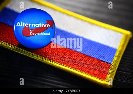 Distintivo AFD sulla bandiera russa, foto simbolica per una possibile vicinanza dell'AfD alla Russia, Parteianstecker der AfD auf einer Fahne von Russland, Foto Stock