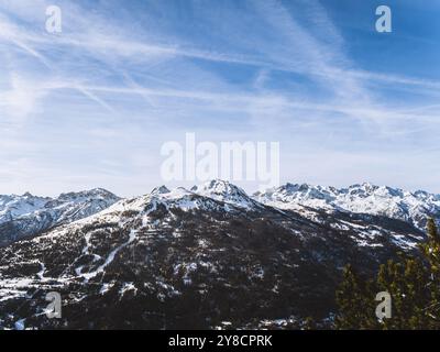 Una splendida vista sulla cima innevata del Serre Chevalier di Brianza, su un cielo azzurro e limpido. L'aspro paesaggio montano ne mette in mostra la bellezza Foto Stock