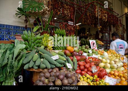 Colorato spettacolo di frutta e verdura esotica in un vivace mercato di Funchal Foto Stock