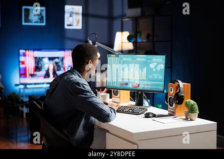 Esperto finanziario che esamina la situazione economica online, svolge attività di contabilità per la revisione del bilancio giuridico. Il consulente economista calcola i ricavi dei fondi di capitale, gestendo gli investimenti a casa. Foto Stock