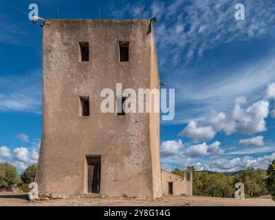 Ancient country church of Sant'Isidoro and the homonymous tower, Teulada, Italy Stock Photo